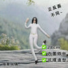 A white plush doll resembling Michael Jackson standing outdoors on a rock, showing the back view.