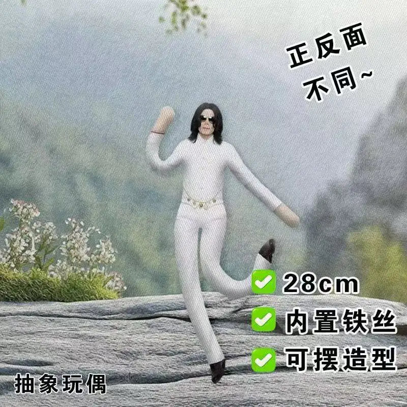A white plush doll resembling Michael Jackson standing outdoors on a rock, showing the back view.