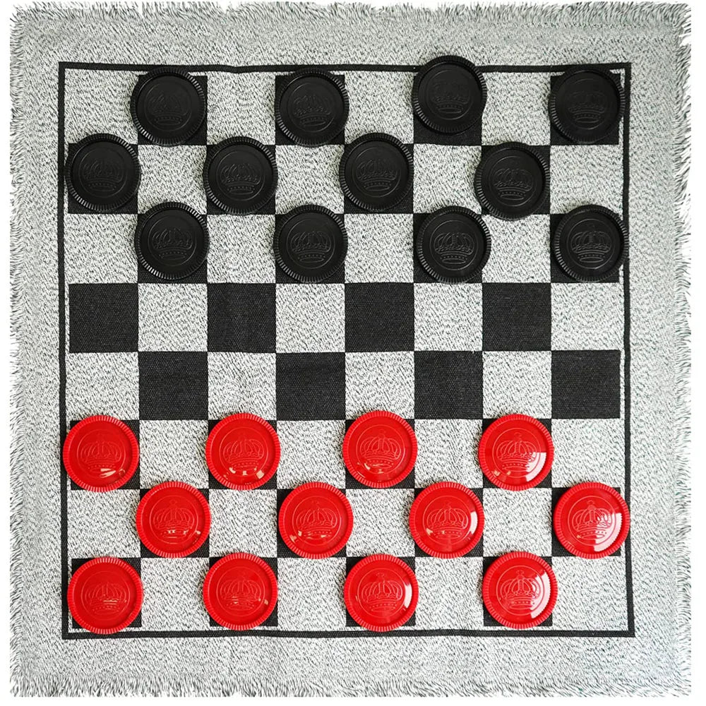 A black and white checkerboard game rug with 24 pieces set for checkers and tic tac toe