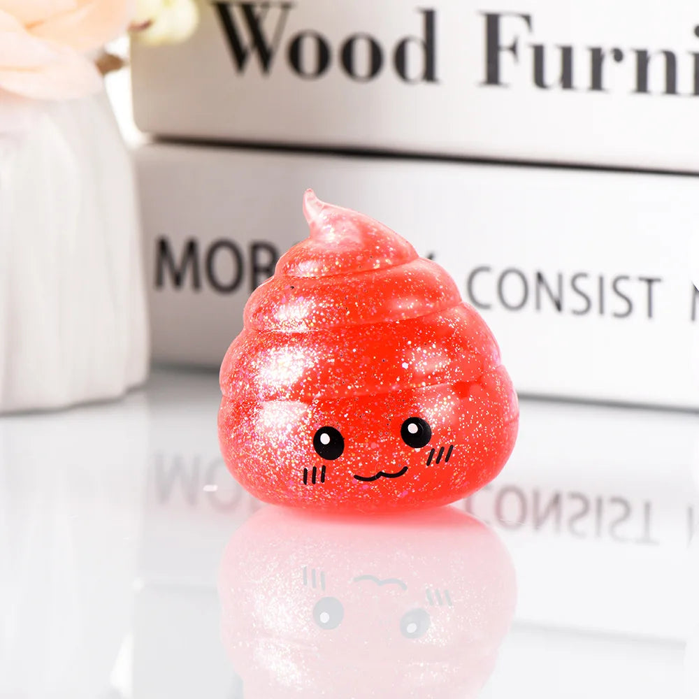A bright red glitter squishy stress ball with a cute, smiling face resting on a reflective surface.