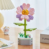 A colorful building block bouquet set featuring pink and purple rose flowers on a green stem.