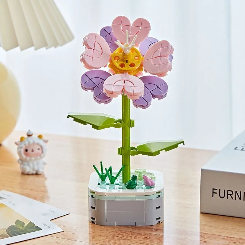 A colorful building block bouquet set featuring pink and purple rose flowers on a green stem.