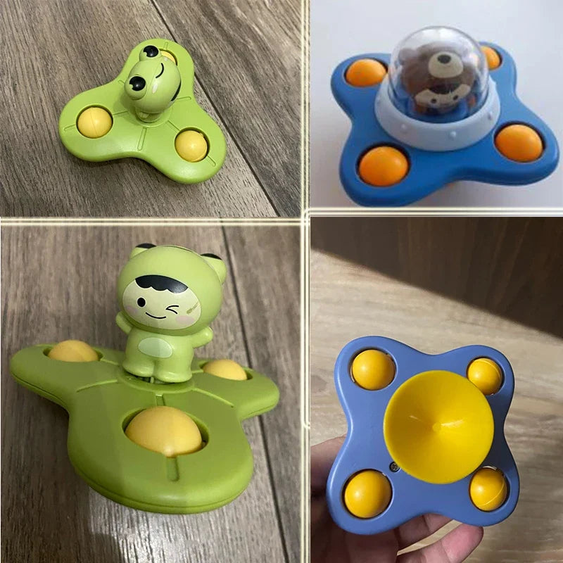 A collection of green and blue suction cup spinner bath toys for toddlers, including a green duck and a blue sphere.