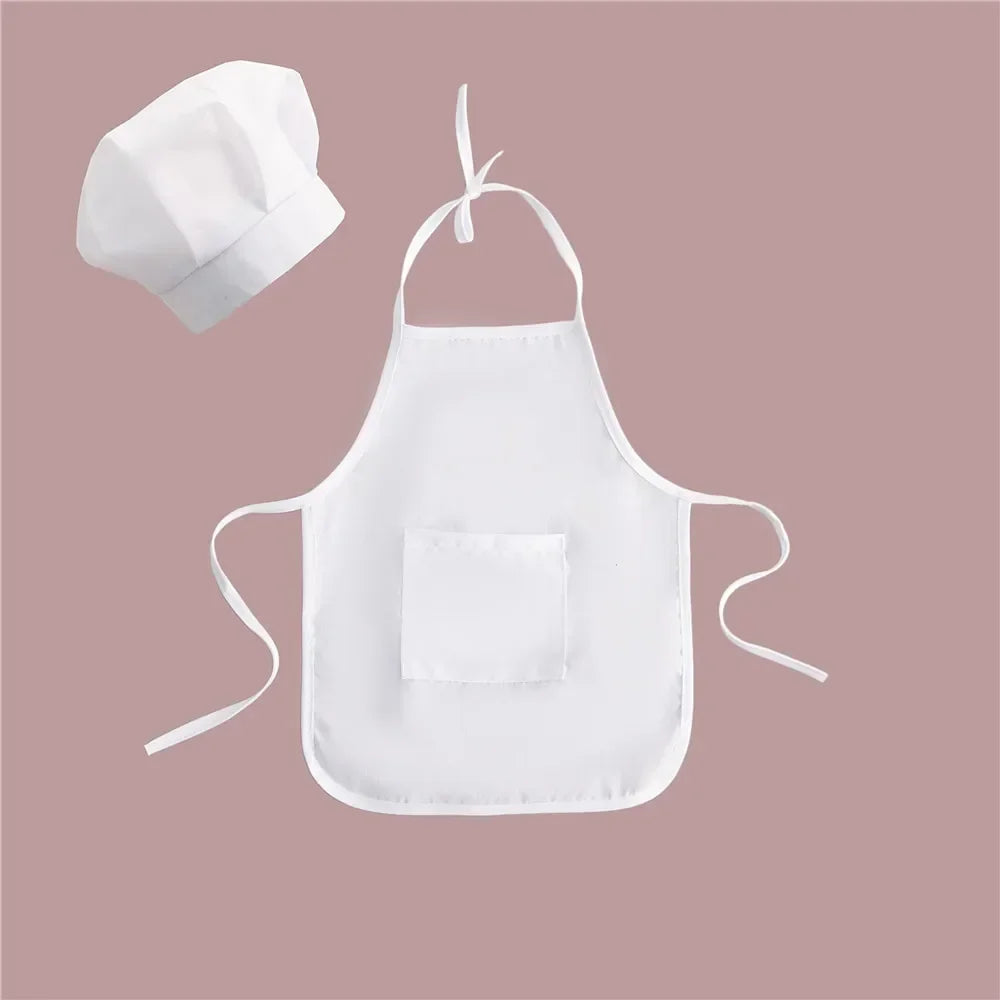 White kids chef apron and hat set for pretend play displayed on a pink background
