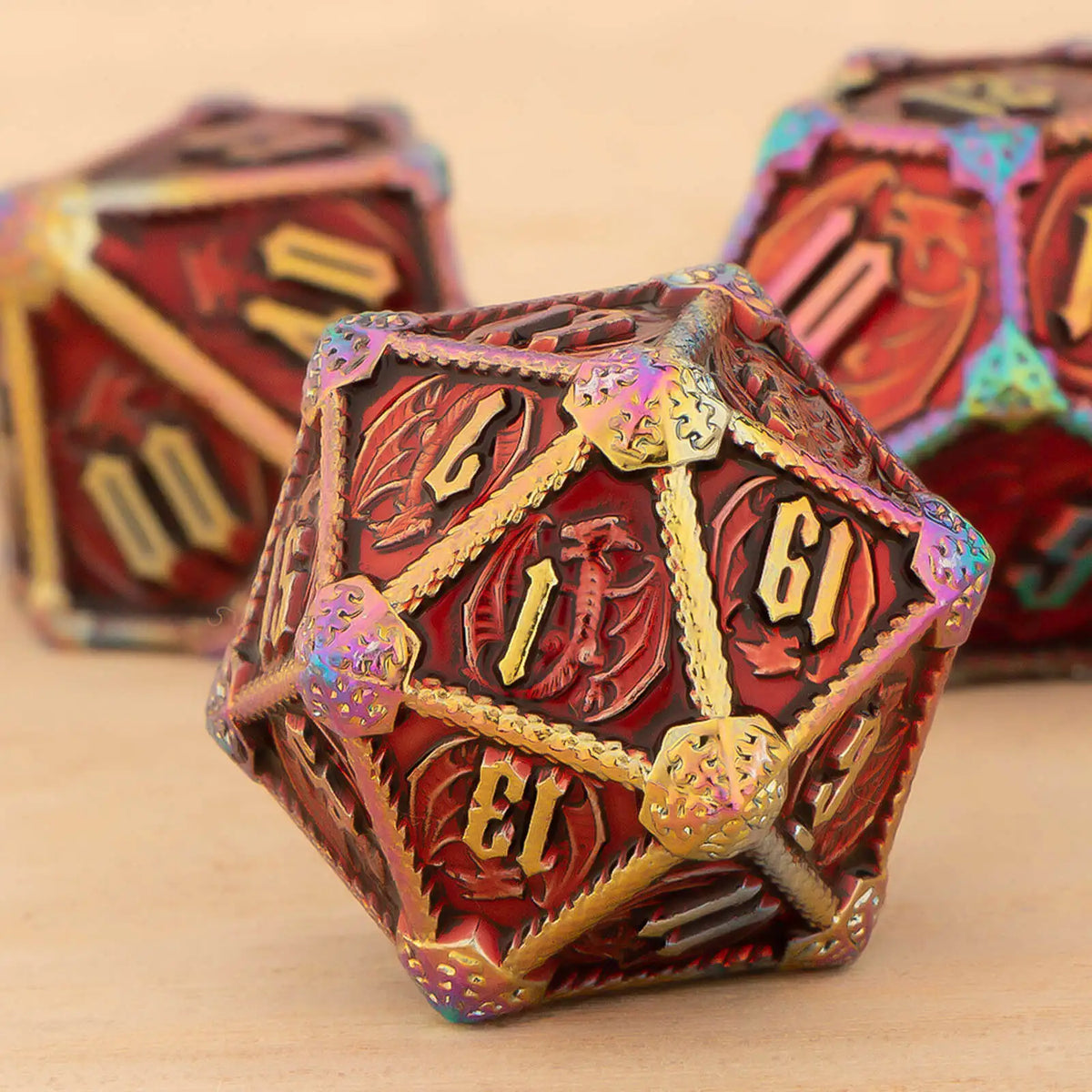 A close-up of a red and gold polyhedral metal dice set, likely for tabletop gaming.