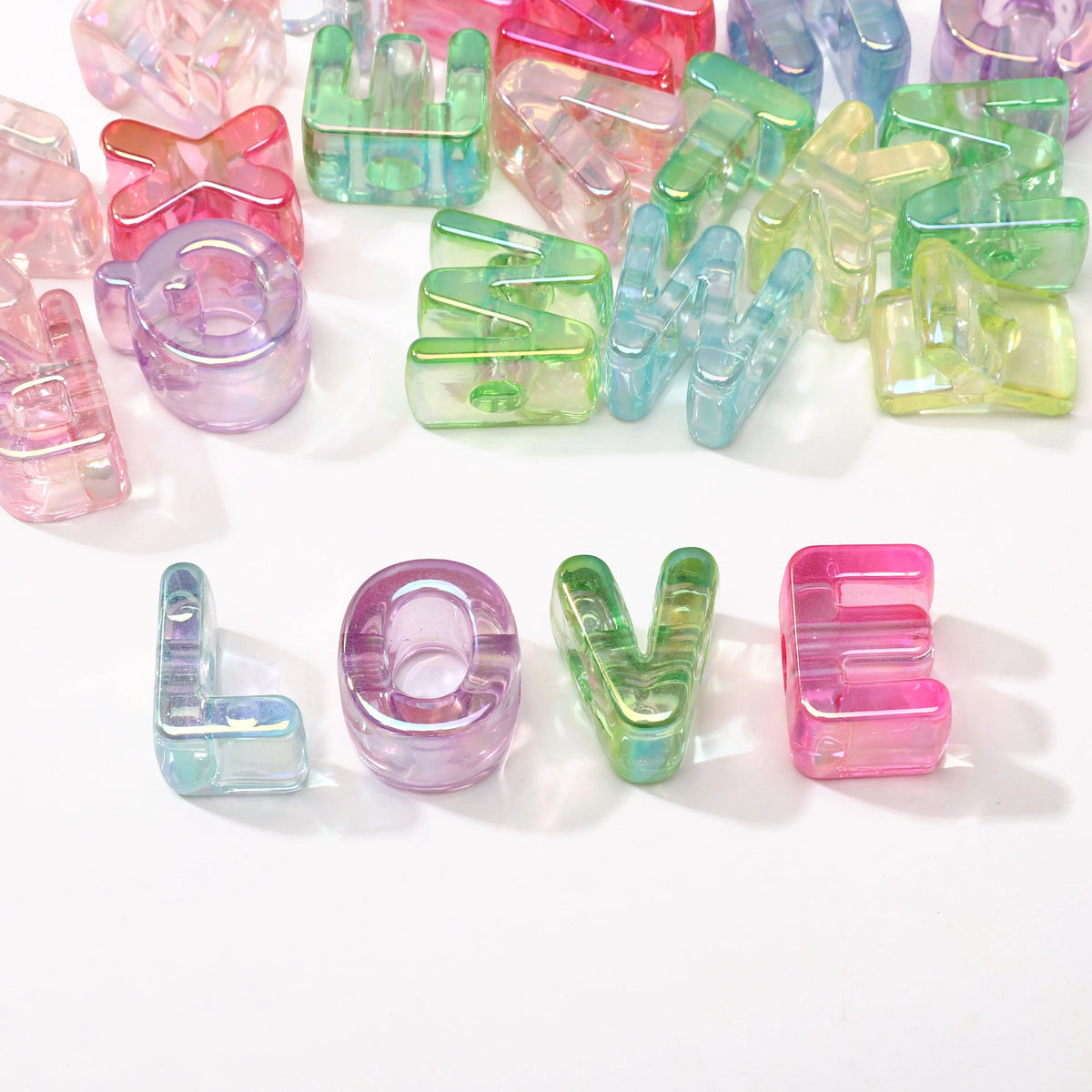 A collection of colorful acrylic alphabet beads in various shades and shapes for jewelry making