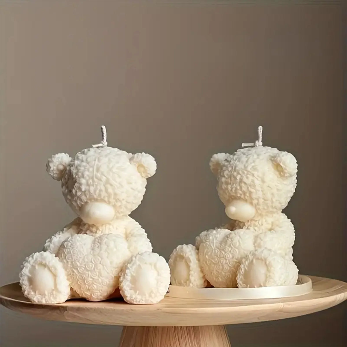 White silicone mold shaped like a teddy bear hugging a heart for candles and resin