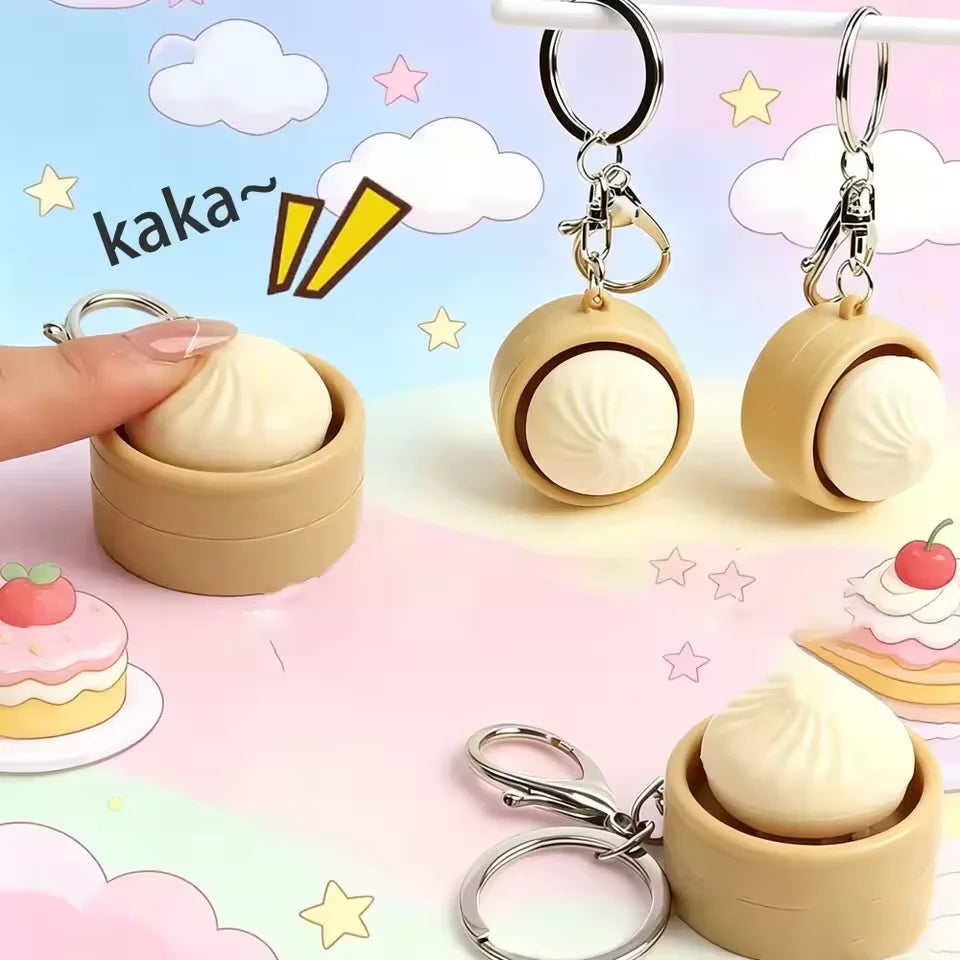 A set of cute, round, beige dumpling-shaped stress relief keychains with attached rings and a small LED light.