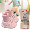 Pink baby soft sole first walker shoes with anti-slip TPR soles shown on a child and in detail.