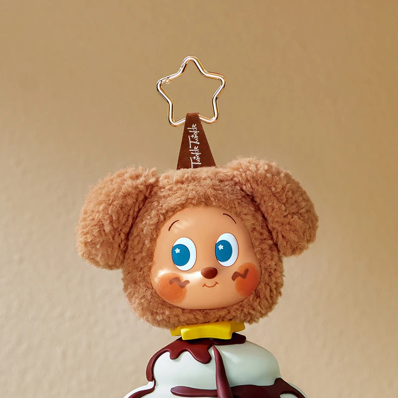 A cute, fluffy brown bear-like character with large blue eyes and a gold star accessory, wearing a white and maroon design.