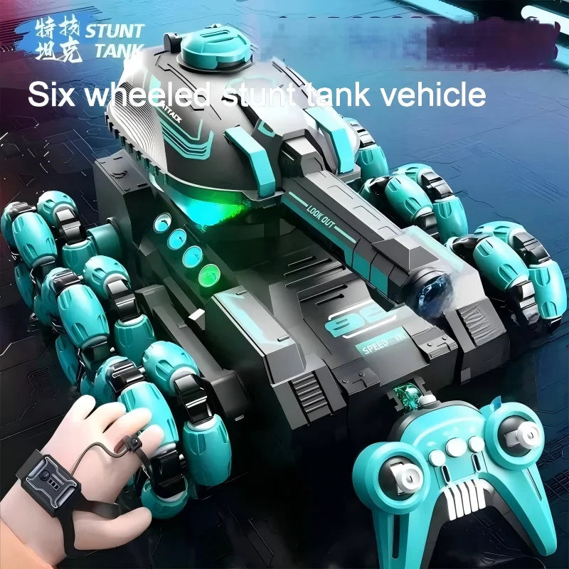 A black and teal six-wheeled stunt tank vehicle is shown with a hand holding a controller.