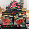 Boxed watermelon squishy fidget toys with various designs and colors for stress relief