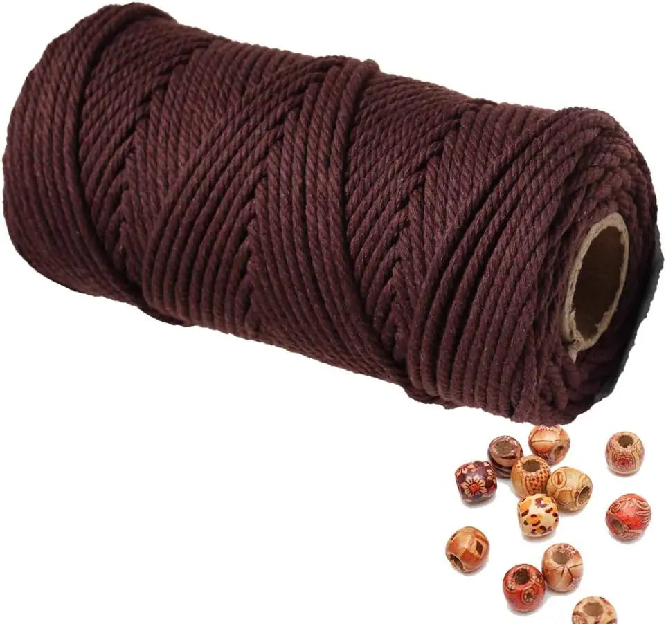 A roll of dark brown natural cotton macrame rope used for crafts and decor.