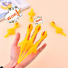 A hand holds several yellow catapult chicken flying toys with speech bubbles showing wow and goo.