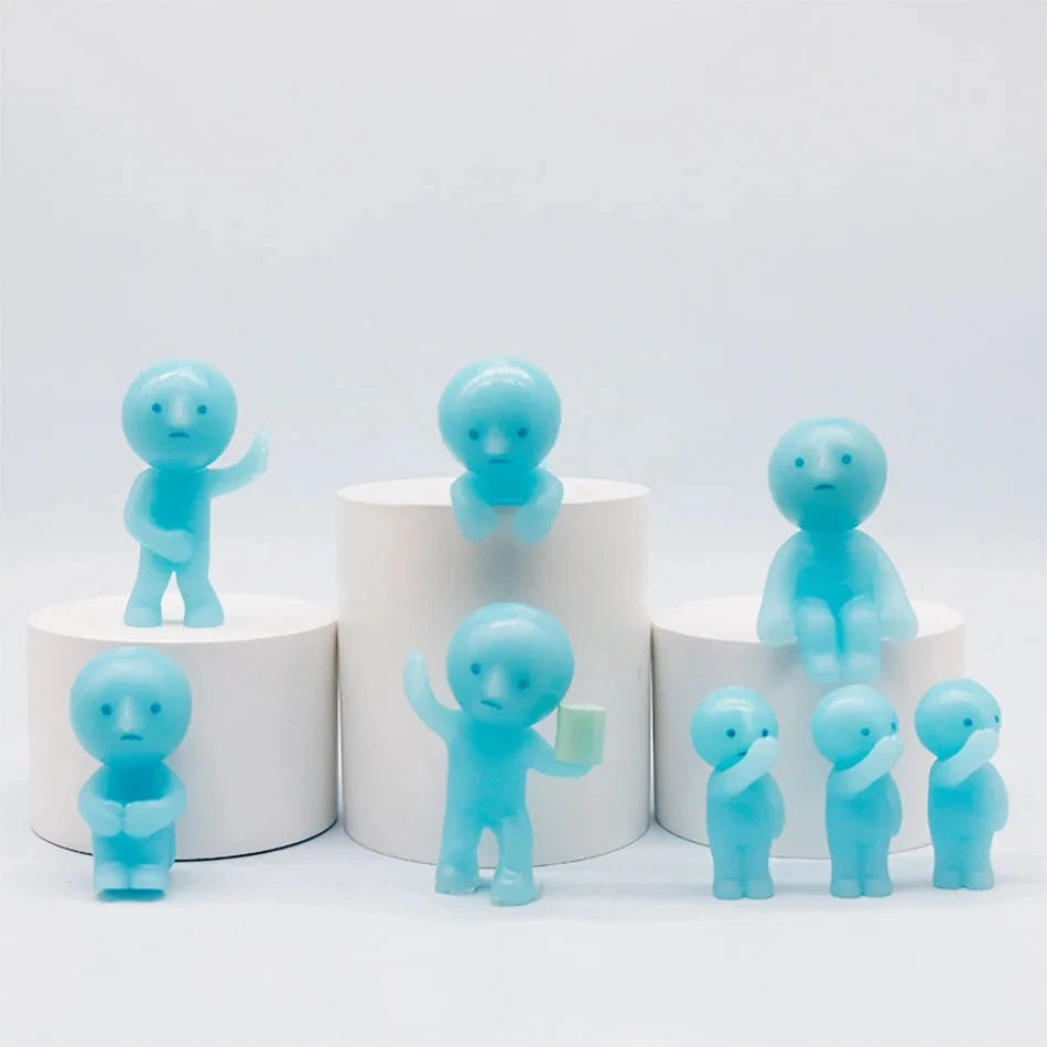 A collection of small, translucent blue glow-in-the-dark fitness figurines displayed on white circular stands.