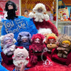 A collection of Skullpanda You Found Me! figures in various colors and textures displayed on a blue and red fabric background