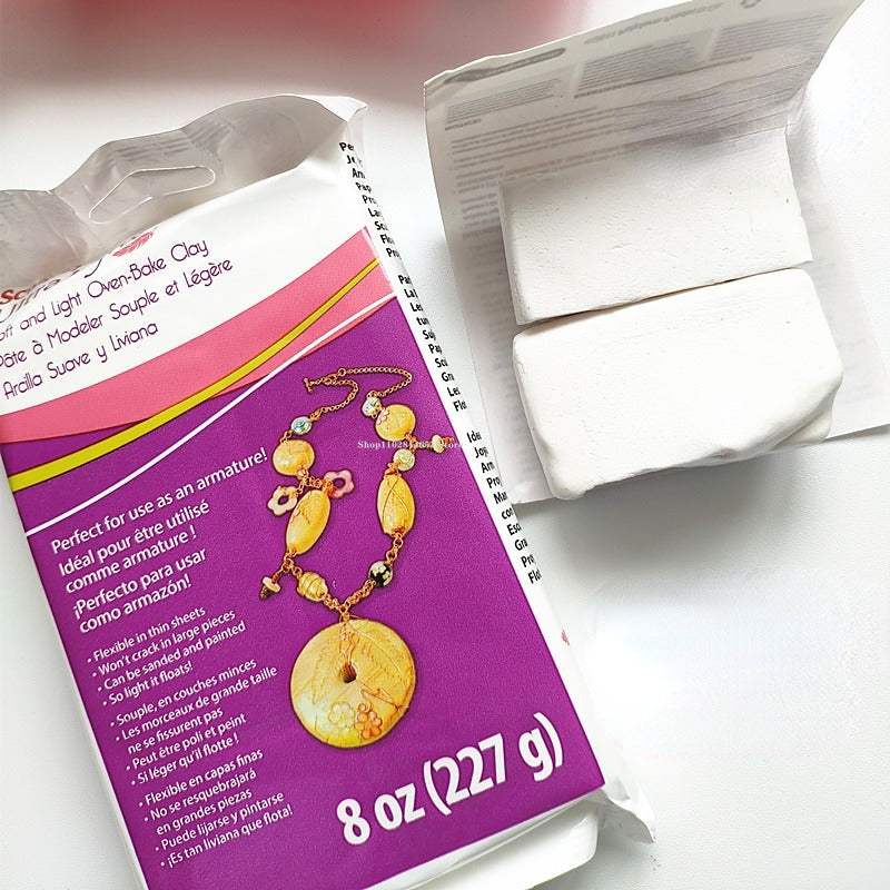 A purple package of polymer clay blocks for jewelry making with instructions and a white block visible.