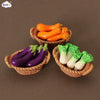 A miniature dollhouse vegetable basket play set showing orange and purple bell peppers and green chili peppers.