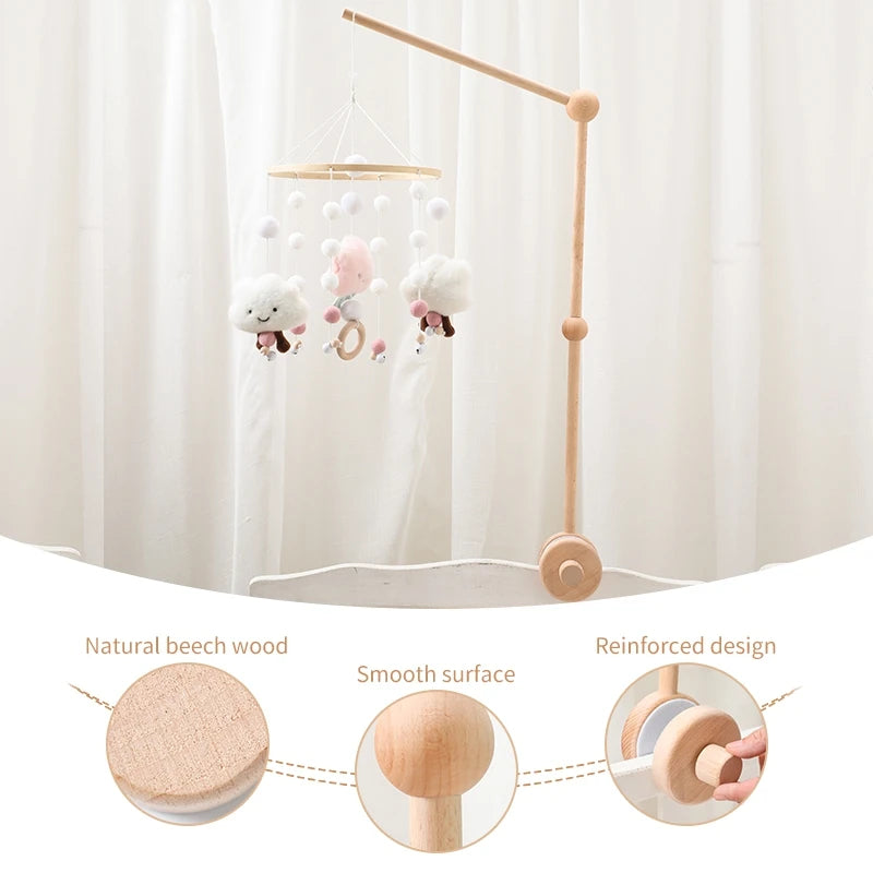A wooden felt forest animal crib mobile hanging from a light fixture with a long wooden arm.