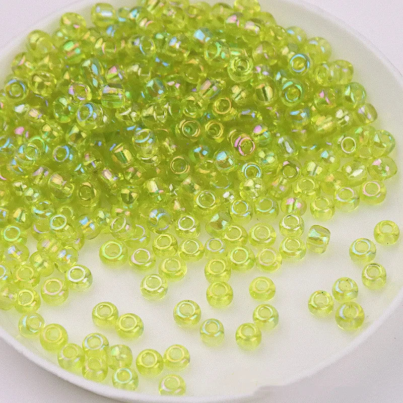 A pile of bright lime green glass rice beads for DIY jewelry and crafting.