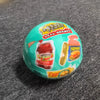 A green ball toy featuring various snack brands like Smucker's and Spam on its surface.