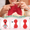 A handmade crochet flamingo toy in red is shown being held by a person.