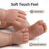 Close-up of a baby's foot and hand showing soft skin texture and painted details on a realistic reborn doll.