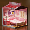 A miniature DIY dollhouse kit featuring pink furniture and room themes, including a bed and storage shelves.