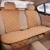 A tan upholstered car seat protector with quilted padding is shown inside a vehicle cabin.