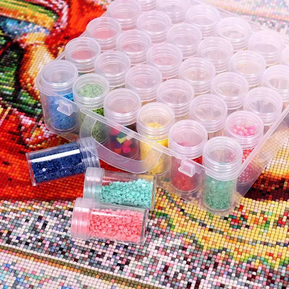 A collection of small colored beads and glitter is organized in clear plastic containers and trays for a diamond painting kit
