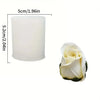 A white cylindrical silicone mold with a fluted design, shown next to a realistic white rose flower.