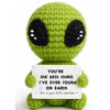 Handmade crochet sunflower pot doll with green body and black eyes sitting on a white background.