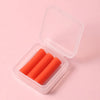 A clear plastic box contains three orange gradient rotating dotting pens for nail art and rhinestone application.