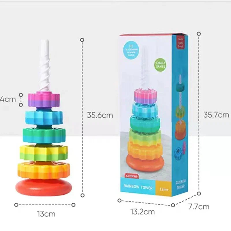 A colorful rainbow spinning stacking tower toy for toddlers shown next to its packaging.
