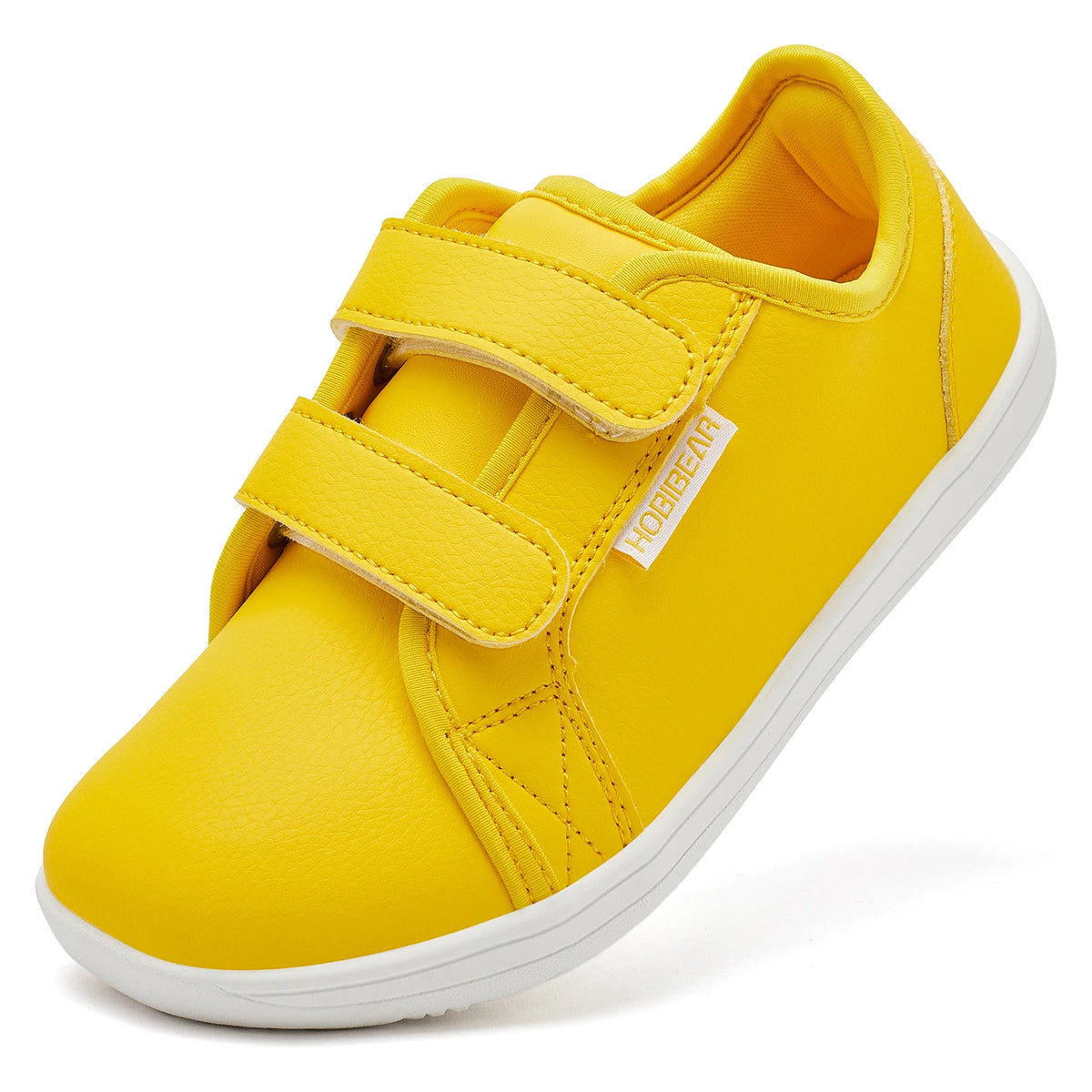 A bright yellow pair of kids barefoot sneakers with double hook-and-loop straps shown from the side.