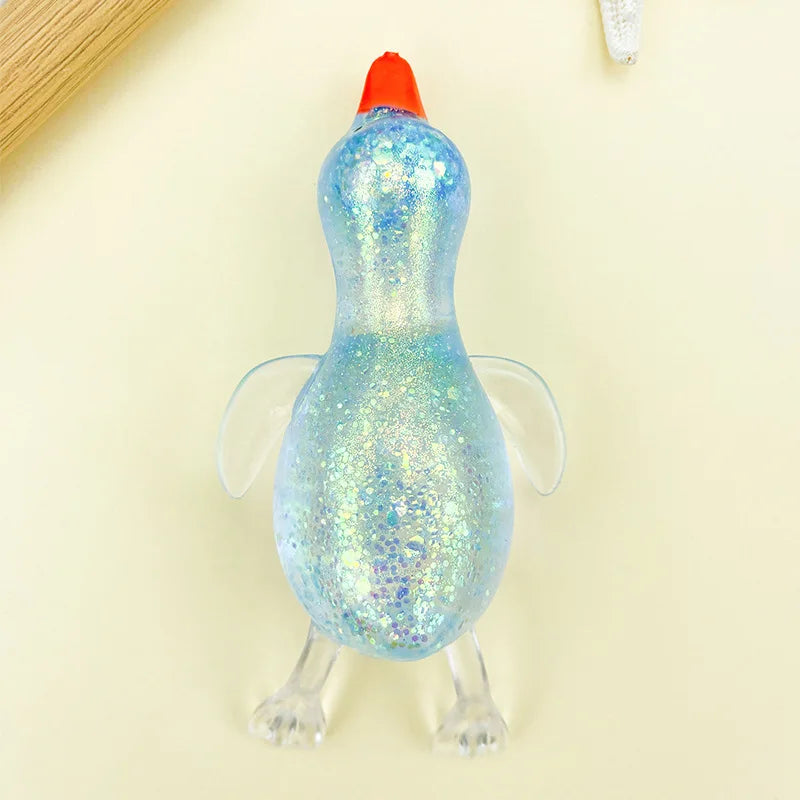 A bright blue, glittery duck squeeze toy with an orange beak is shown against a light background.