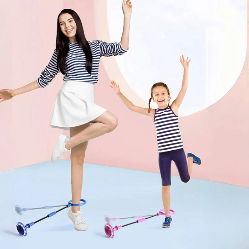 A young girl is balancing on a glowing skip ball while holding a purple skipping rope.