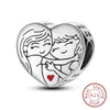 A sterling silver heart charm depicting two smiling figures embracing, with a small red heart detail.