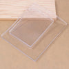 Clear silicone gel printing plates stacked on a light wooden surface for mixed media art