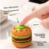 An orange and green burger-shaped stress relief toy is being pressed by a finger, demonstrating its mechanical feel.