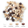A collection of brown, white, and tan silicone lentil beads arranged in a wooden tray.