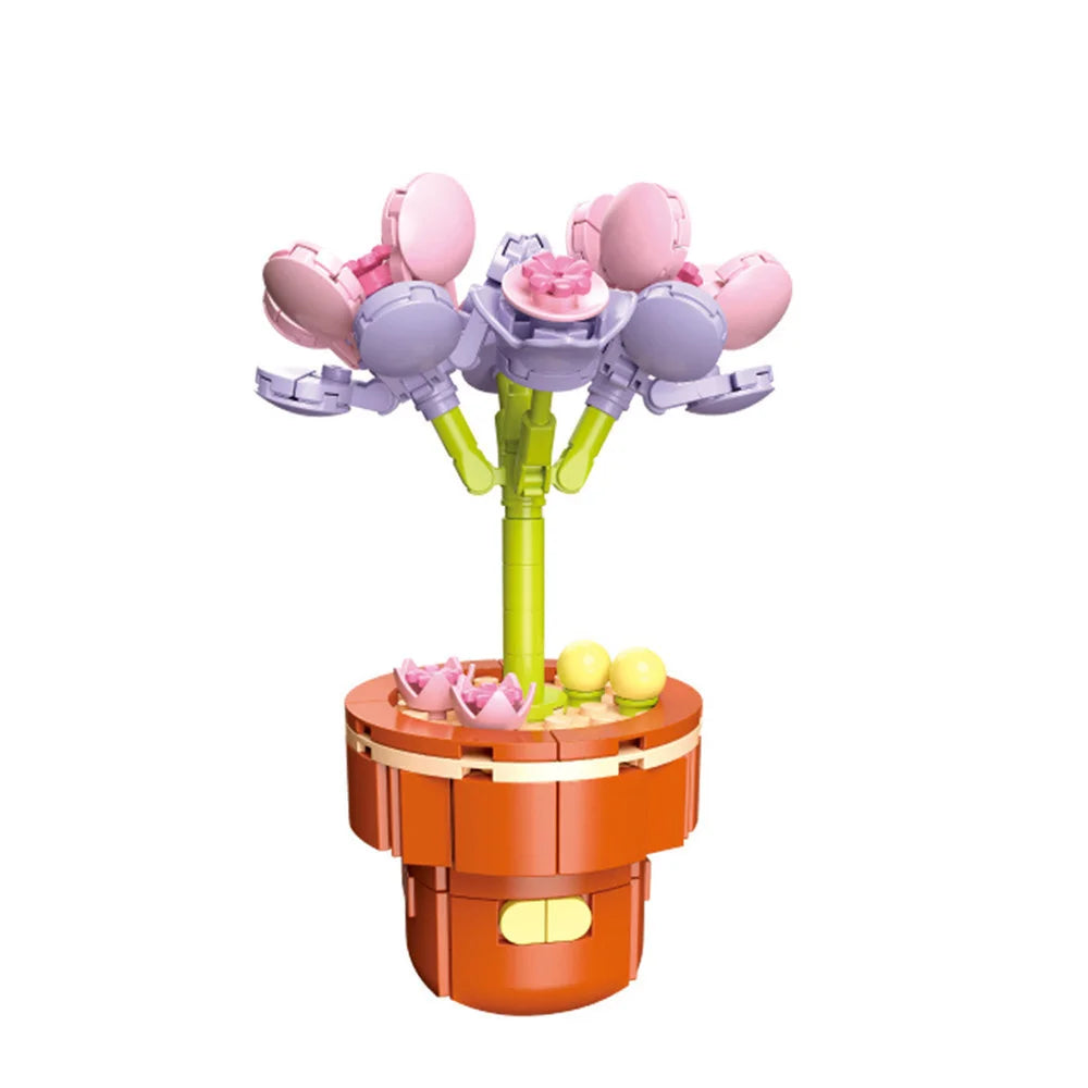 A set of pink and purple city creativity building blocks with a green stand and an orange base.