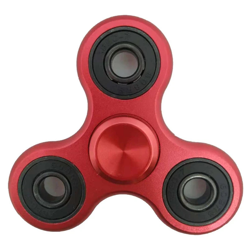 A close-up view of a red aluminum alloy fidget spinner with precision bearings.