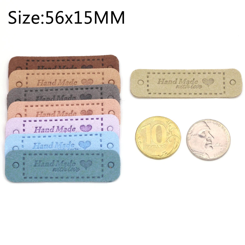 A set of 20 leather-style handmade with love tags in various colors and a gold coin.