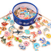 A collection of wooden magnetic fishing game pieces in various shapes and colors inside a blue bowl.