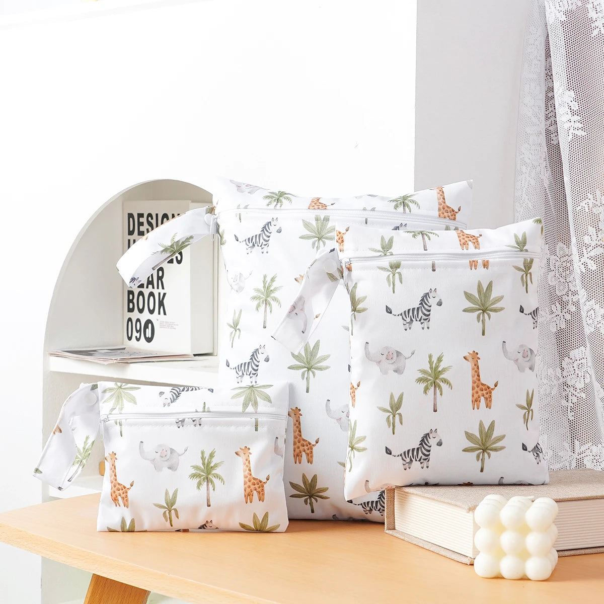 A pack of three white waterproof wet and dry bags featuring jungle animal patterns for swimsuits, diapers, and travel.
