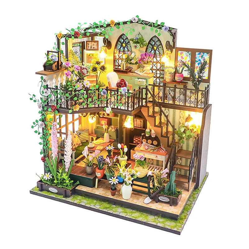 A detailed DIY miniature dollhouse kit featuring furniture, plants, and warm lighting.