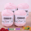 Four skeins of pink cotton knitting yarn labeled Golden Sun for crochet and handmade projects