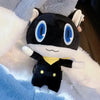 A black and white plush doll of Morgana from Persona 5 wearing a yellow shirt.