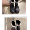 A pair of black women's waterproof mid-calf rain boots with white accents and a non-slip sole.